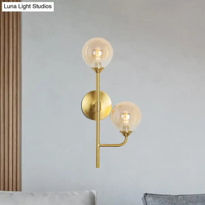 Brass sphere bathroom sconce with dual globe bulbs, wall-mounted by Decorbites on Tampa Home & Garden Store