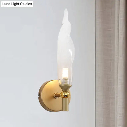 Brass torch wall sconce with gold finish and candle-shaped bulb by Decorbites on Tampa Home & Garden Store