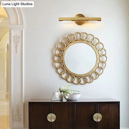 Brass Tube Vanity Light by Decorbites with gold finish above a round linked-ring mirror on Tampa Home & Garden Store