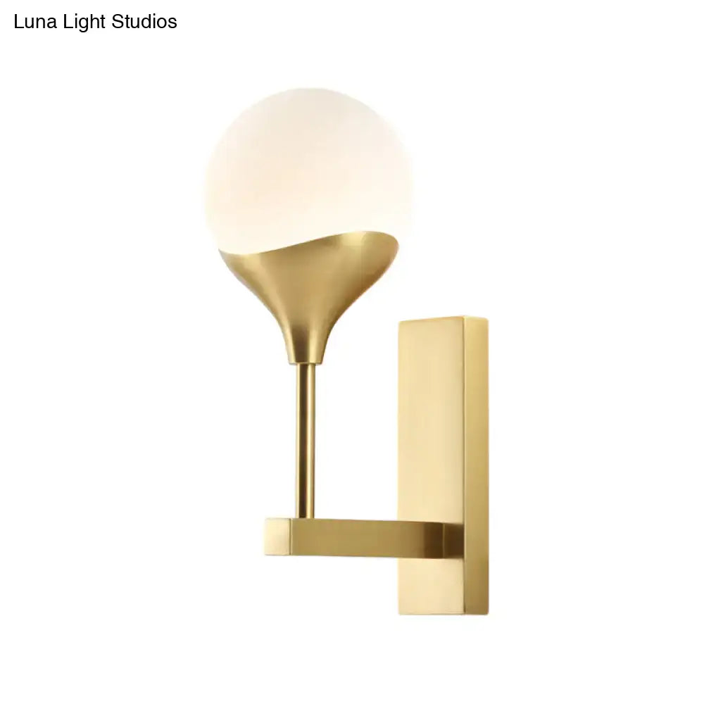 Brass cream glass wall lamp by Decorbites with round globe shade and rectangular backplate on Tampa Home & Garden Store