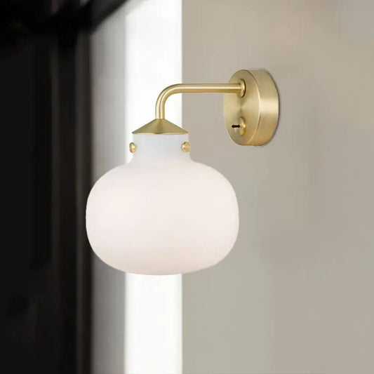 Brass milk glass balcony sconce by Decorbites with curved arm and frosted globe on Tampa Home & Garden Store