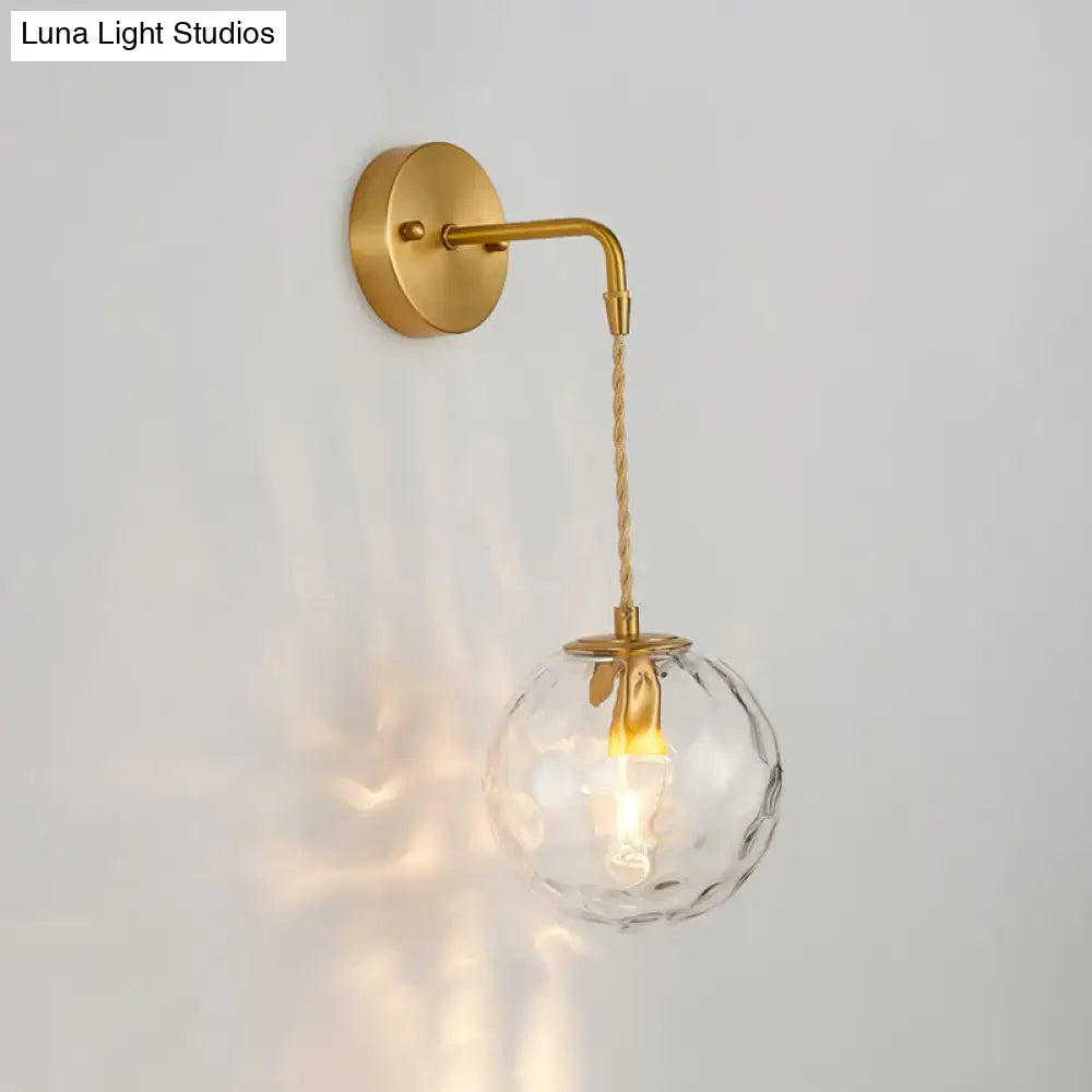 Brass Water Glass Sconce with clear textured glass globe and twisted rope cord wall mount on Tampa Home & Garden Store