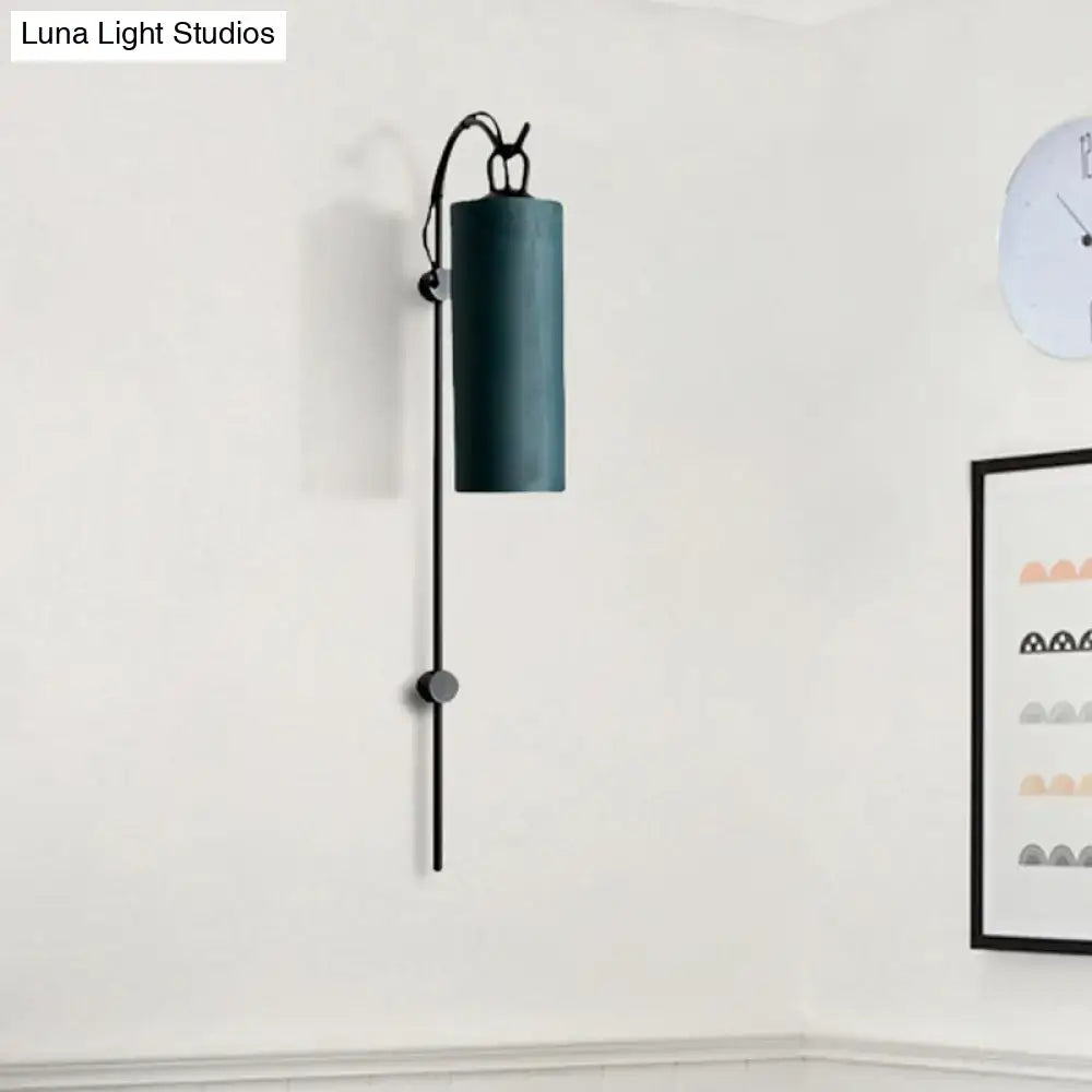 Brass White Tube Sconce by Decorbites with cylindrical shade on a black vertical wall arm on Tampa Home & Garden Store