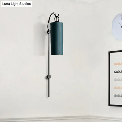 Brass White Tube Sconce by Decorbites with cylindrical shade on a black vertical wall arm on Tampa Home & Garden Store