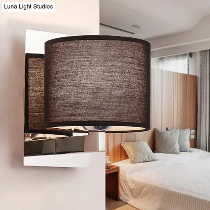 Brown cylinder fabric shade wall sconce with dark metal backplate in modern bedroom decor on Tampa Home & Garden Store