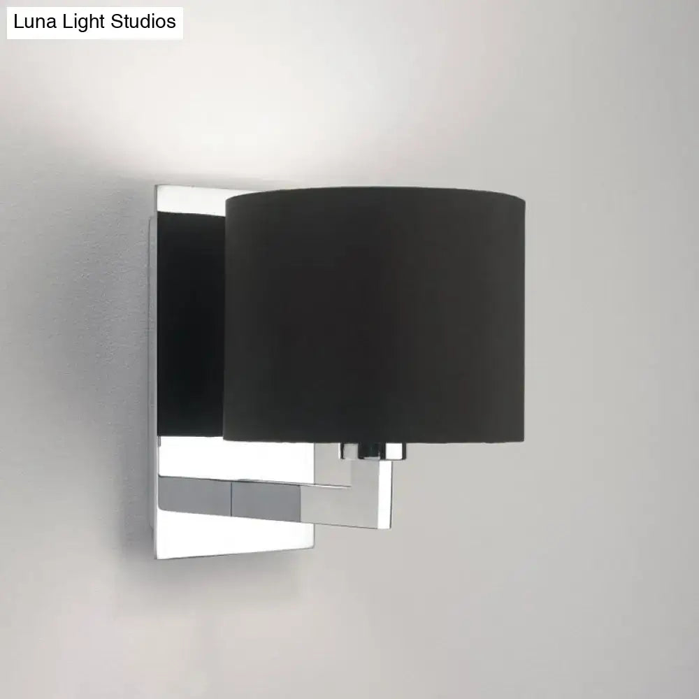 Brown cylinder wall sconce with chrome backplate and black fabric shade on Tampa Home & Garden Store