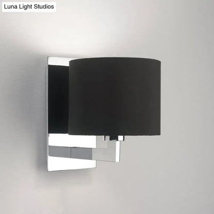 Brown cylinder wall sconce with chrome backplate and black fabric shade on Tampa Home & Garden Store