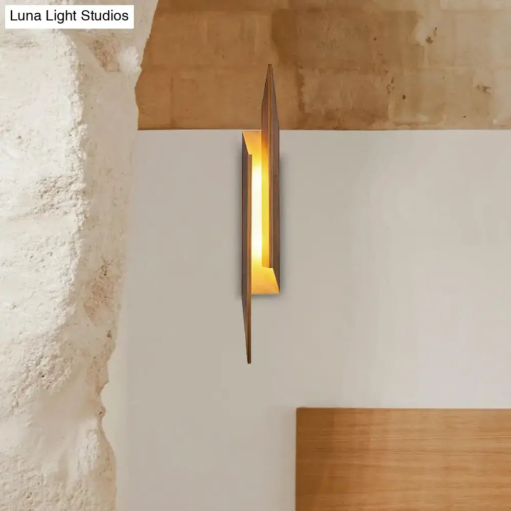 Brown metal geometric sconce with warm amber glow, Decorbites wall decor on Tampa Home & Garden Store