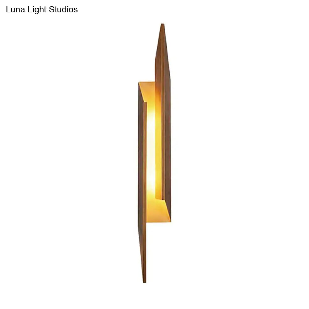 Brown metal geometric wall sconce with warm amber glow by Decorbites on Tampa Home & Garden Store