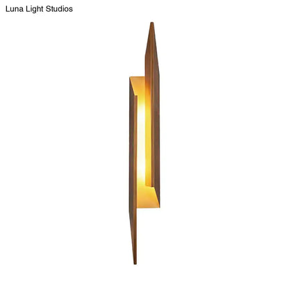 Brown metal geometric wall sconce with warm amber glow by Decorbites on Tampa Home & Garden Store