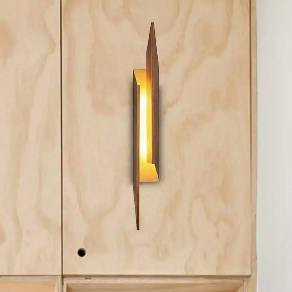 Brown metal geometric wall sconce by Decorbites with warm glow on Tampa Home & Garden Store