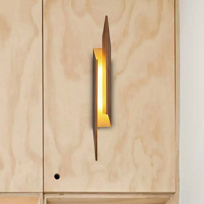 Brown metal geometric wall sconce by Decorbites with warm glow on Tampa Home & Garden Store