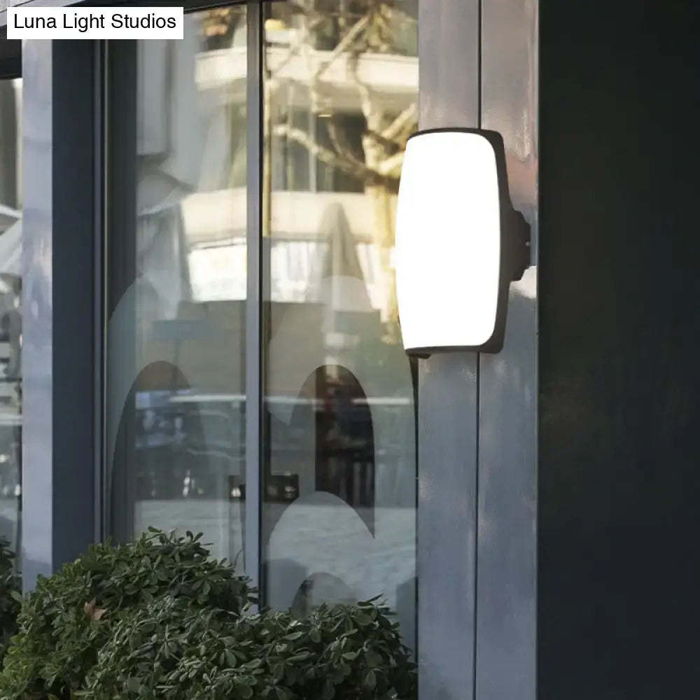 Brown rectangular LED wall light with bronze finish and frosted glass shade on exterior wall on Tampa Home & Garden Store