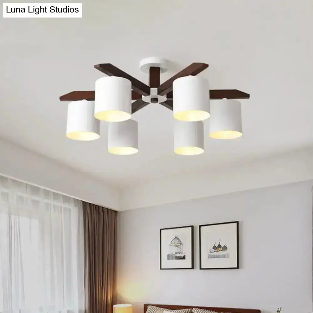 White and brown ceiling chandelier with six cylindrical white shades and dark wood arms on Tampa Home & Garden Store