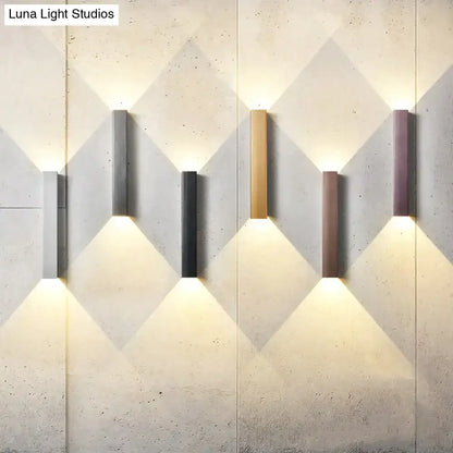 Decorbites modern brushed aluminum rectangular wall sconces for bedroom ambient light, five finishes with uplight on a textured wall on Tampa Home & Garden Store