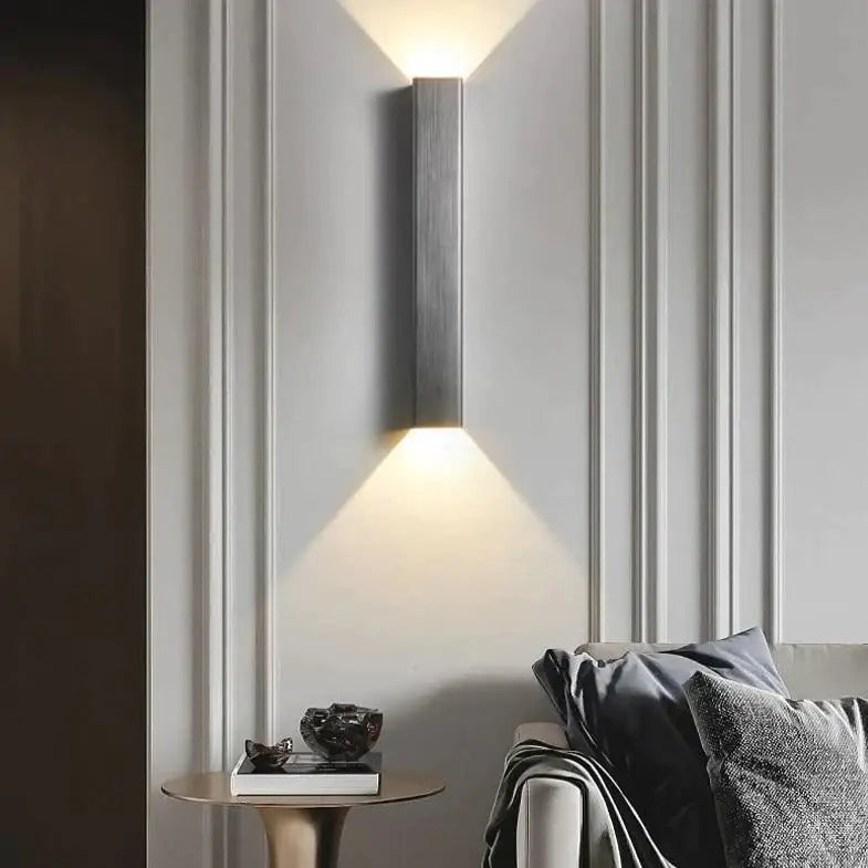 Modern brushed aluminum rectangular wall sconce by Decorbites with upward glow on paneled wall on Tampa Home & Garden Store