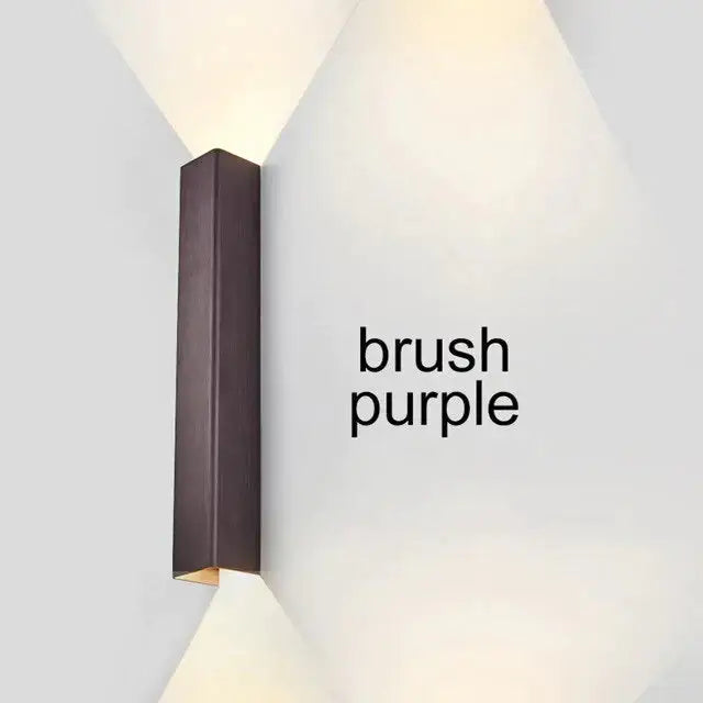Brushed aluminum rectangular wall sconce with ambient upward glow on Tampa Home & Garden Store