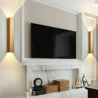 Pair of modern brushed aluminum rectangular wall sconces with up and down ambient lighting on Tampa Home & Garden Store