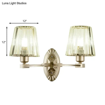 Decorbites modern two-light wall sconce with brushed brass finish and green glass shades on Tampa Home & Garden Store