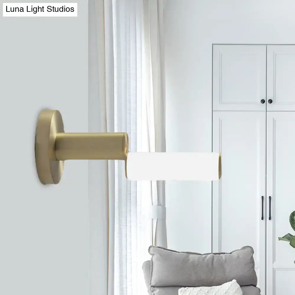 Gold metal wall light with cylindrical white shade from Decorbites on Tampa Home & Garden Store