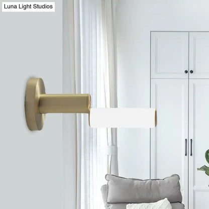 Gold metal wall light with cylindrical white shade from Decorbites on Tampa Home & Garden Store