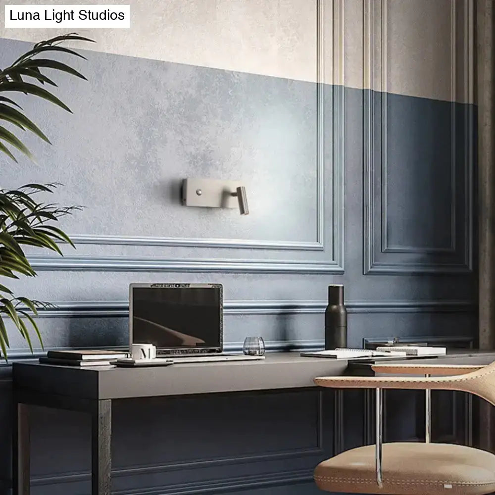 Nickel dimmable wall light fixture on a blue paneled wall above a modern desk on Tampa Home & Garden Store