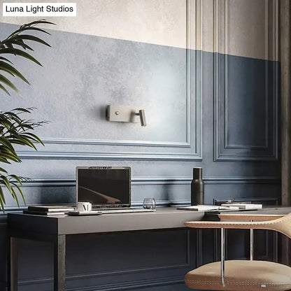 Nickel dimmable wall light fixture on a blue paneled wall above a modern desk on Tampa Home & Garden Store