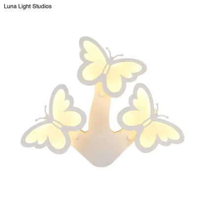 White acrylic wall sconce by Decorbites with three butterfly silhouettes and warm glow on Tampa Home & Garden Store