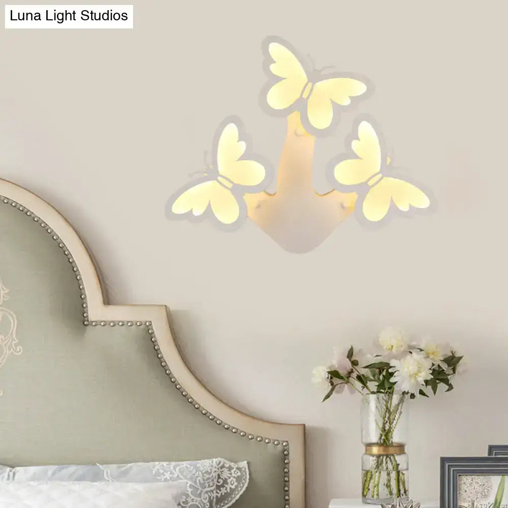 White acrylic wall sconce with butterfly cluster and warm light by Decorbites on Tampa Home & Garden Store