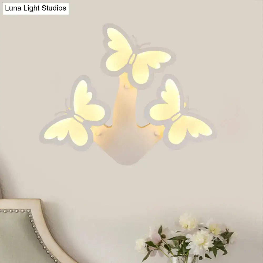 White acrylic wall sconce three-light butterfly design by Decorbites with warm glow on Tampa Home & Garden Store