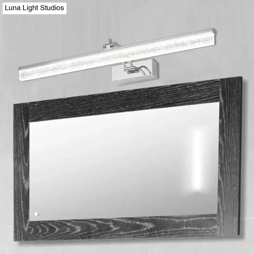 Modern chrome adjustable LED vanity light above a dark wood framed bathroom mirror Decorbites on Tampa Home & Garden Store