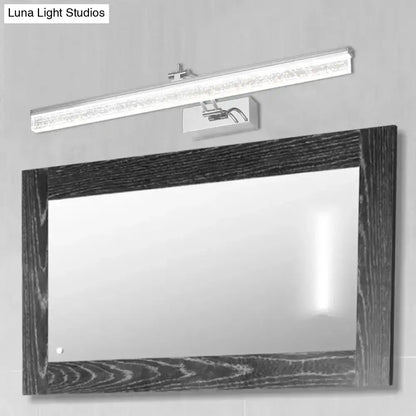 Modern chrome adjustable LED vanity light above a dark wood framed bathroom mirror Decorbites on Tampa Home & Garden Store