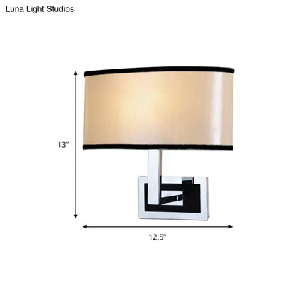 Chrome Oval Wall Sconce with beige fabric shade and black trim by Decorbites on Tampa Home & Garden Store
