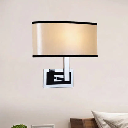 Chrome oval wall sconce by Decorbites with cream shade and black trim on chrome backplate on Tampa Home & Garden Store
