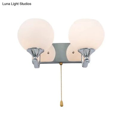 Decorbites chrome cream glass pull-chain sconce with two frosted globes on Tampa Home & Garden Store