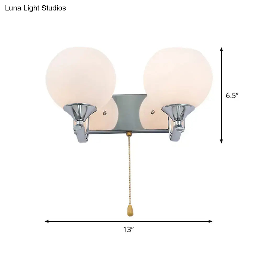Chrome cream glass pull-chain sconce with dual globe shades by Decorbites on Tampa Home & Garden Store