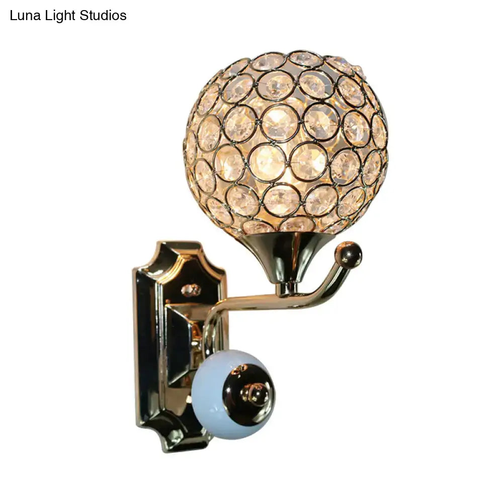 Blue crystal globe sconce with circular disc shade on brass arm wall mount on Tampa Home & Garden Store