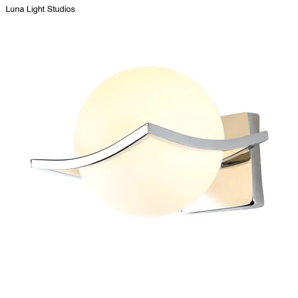 White glass globe wall sconce with chrome curved arm by Decorbites on Tampa Home & Garden Store