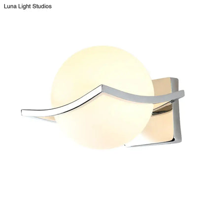 White glass globe wall sconce with chrome curved arm by Decorbites on Tampa Home & Garden Store