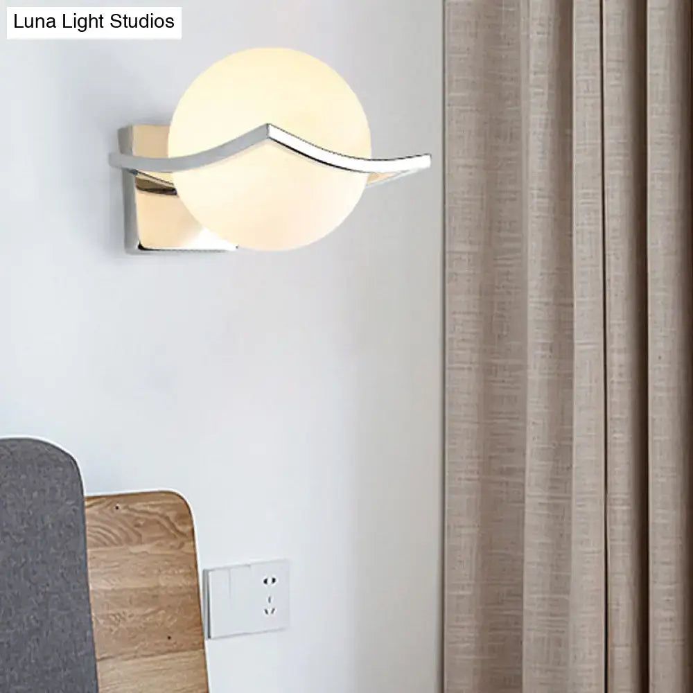 White glass globe sconce with chrome curved arm and square backplate on Tampa Home & Garden Store