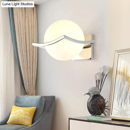 White Glass Globe Wall Sconce by Decorbites with curved chrome arm on a light wall on Tampa Home & Garden Store
