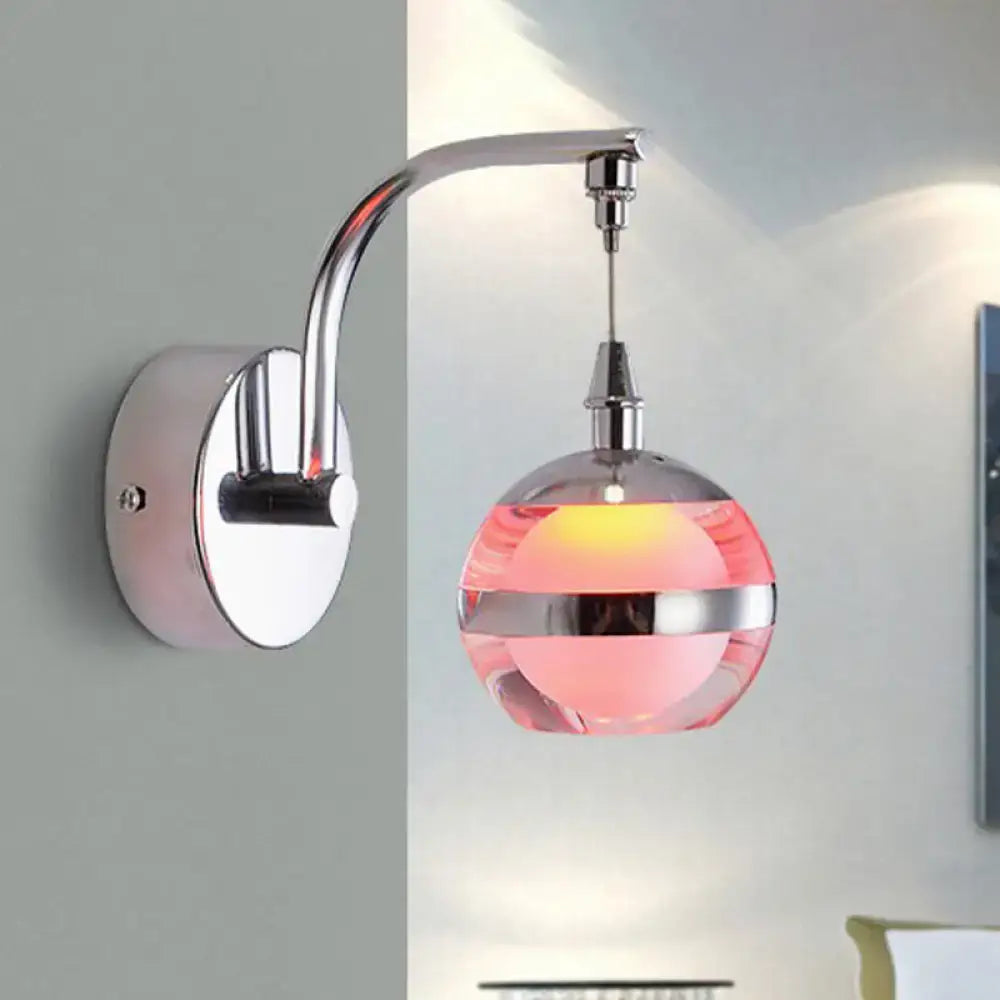 Pink glass globe wall-mounted sconce with chrome curved arm and round backplate on Tampa Home & Garden Store