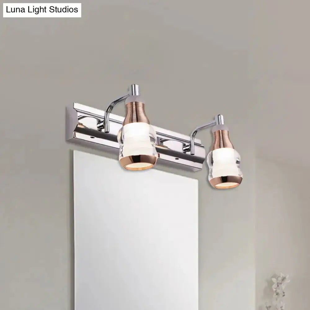 Modern chrome and rose gold two-light vanity light with frosted glass shades by Decorbites on Tampa Home & Garden Store