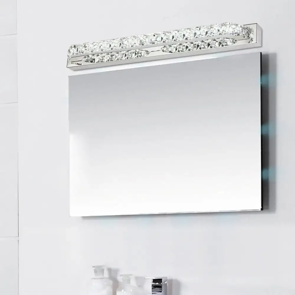 Modern chrome vanity light with clear amber crystal LED bar above bathroom mirror on Tampa Home & Garden Store