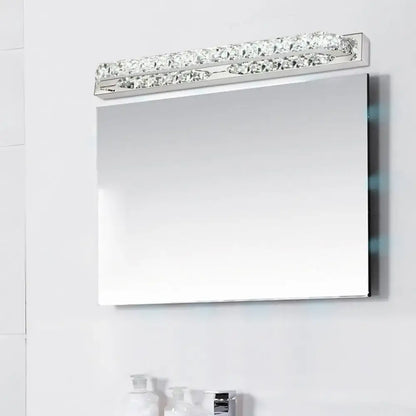 Modern chrome vanity light with clear amber crystal LED bar above bathroom mirror on Tampa Home & Garden Store