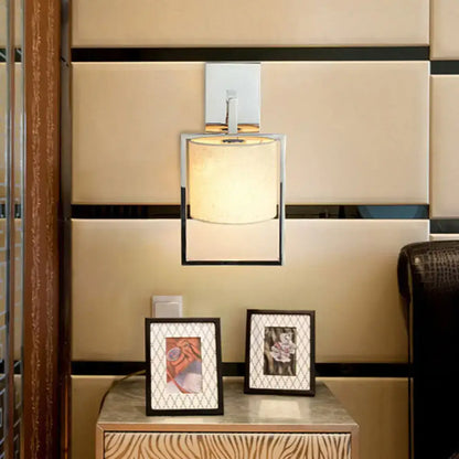 Chrome fabric cylinder sconce with square frame, wall-mounted on beige padded panels on Tampa Home & Garden Store