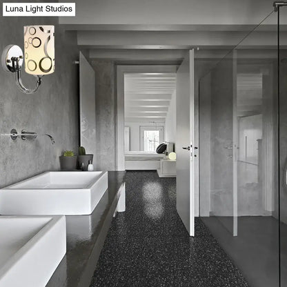 Chrome glass wall sconce by Decorbites with cylindrical shade and circular pattern in bathroom on Tampa Home & Garden Store