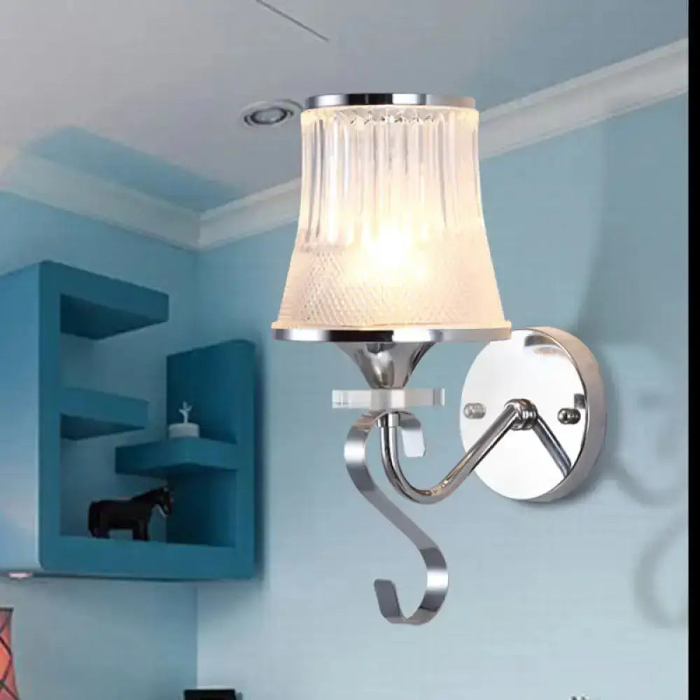 Modern chrome wall sconce with frosted glass shade and curved arm, round backplate on Tampa Home & Garden Store