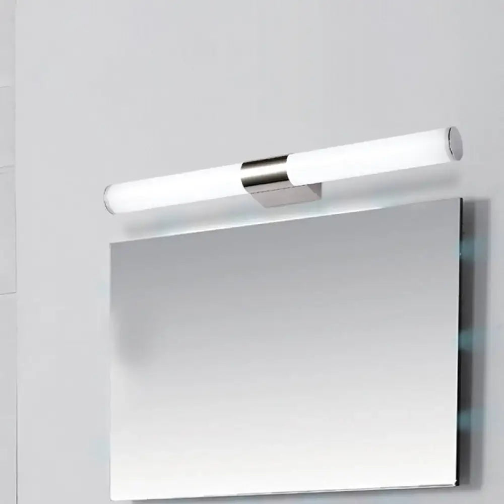 Chrome cylindrical vanity light with frosted tubes above a rectangular mirror on a light wall on Tampa Home & Garden Store