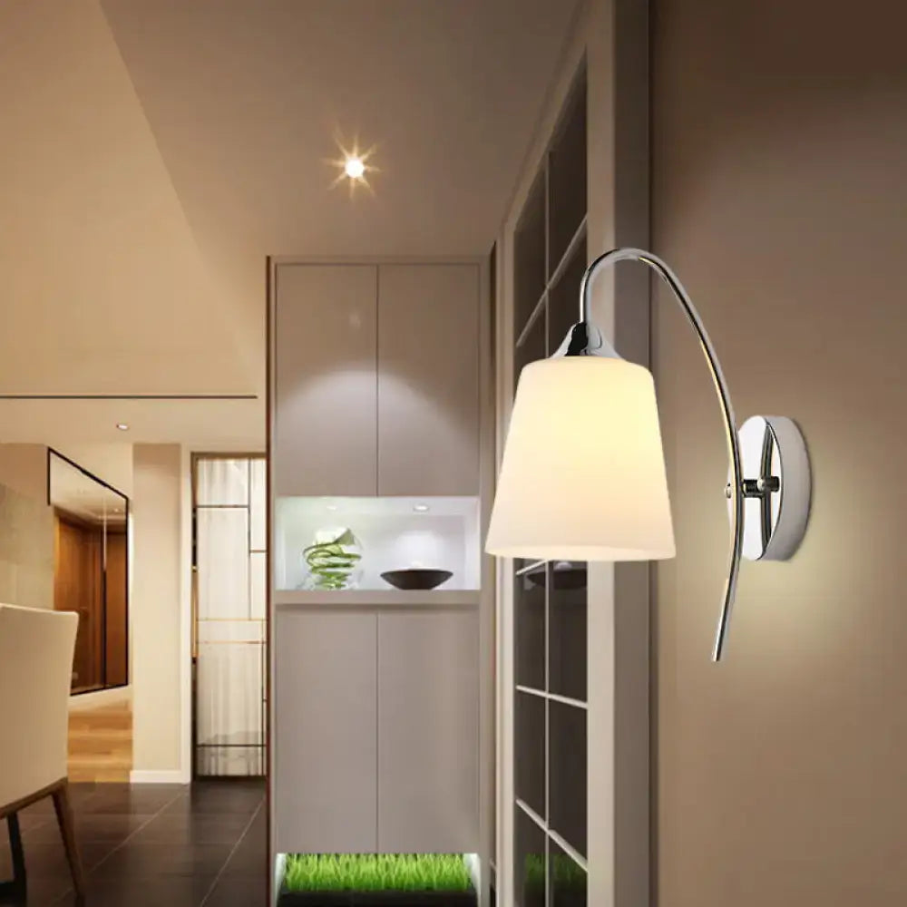Chrome milky glass wall sconce by Decorbites with curved arm and white shade on beige wall on Tampa Home & Garden Store